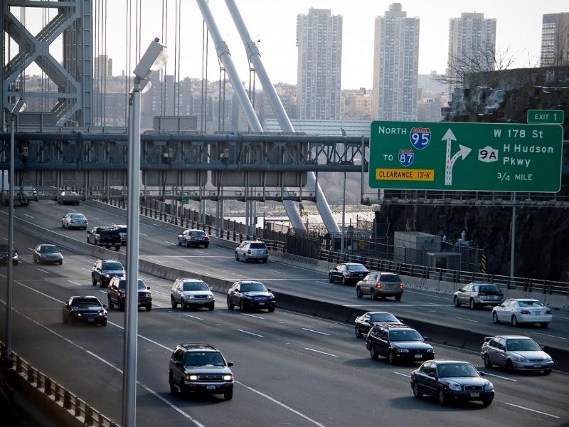 High-volume urban roadway with multiple lanes, traffic flow, highway access points, and transportation infrastructure supporting regional growth