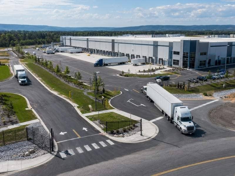 Industrial roadway design with semi trucks entering a warehouse facility in Memphis